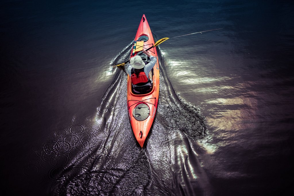 Woman paddling her kayak on a lake